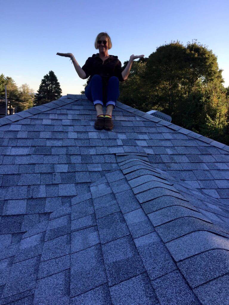 Woman Sitting on New Roof Installed by Marshall Building & Remodeling